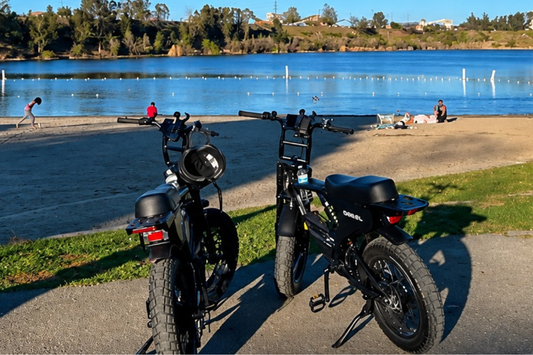 Adult rider on a Diesel electric bike comparing it against a regular bike on a city street