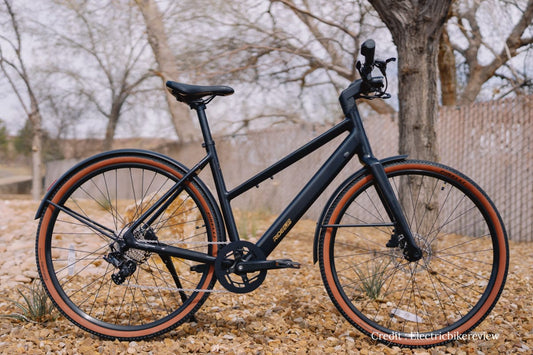 Ride1Up Roadster V3 lightweight electric commuter bike parked on a city street, side profile